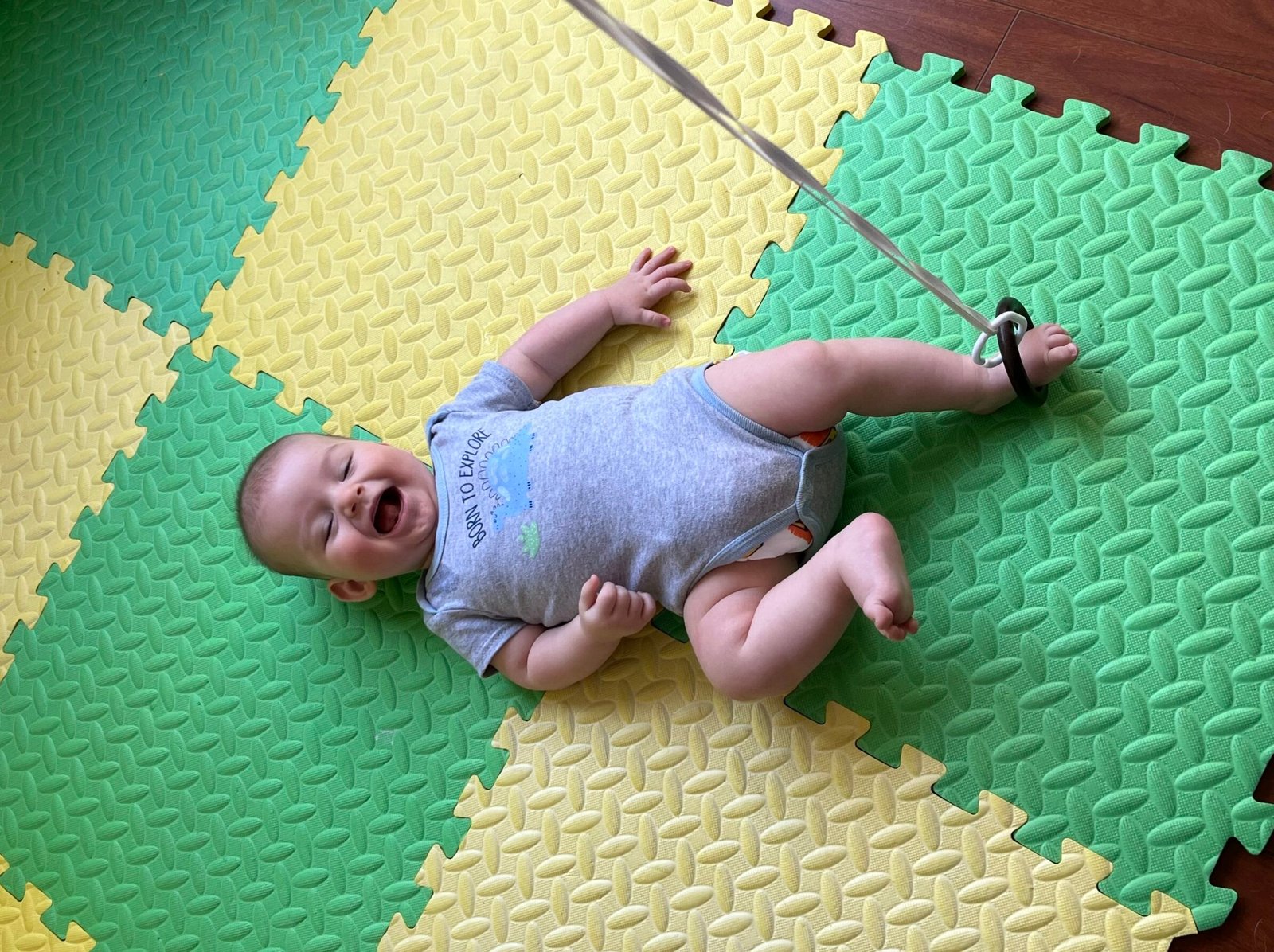 Baby T is excited about his foot ring and this parenting blog